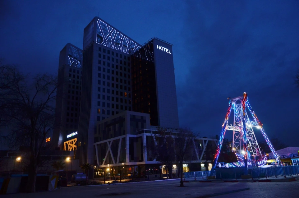 a very tall building with a christmas tree in front of it